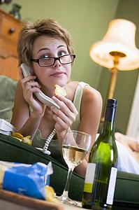 Young woman at home talking on telephone