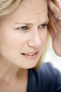 Head shot of woman scowling