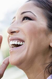 Woman's smiling face outdoors (selective focus)