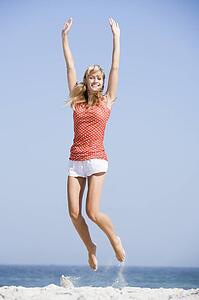Woman jumping on a beach