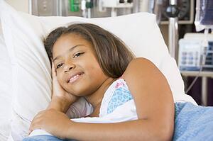 Young Girl Lying Down In Hospital Bed