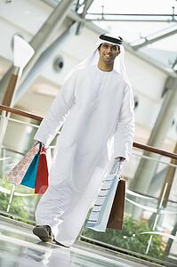 Man walking in mall smiling (selective focus)