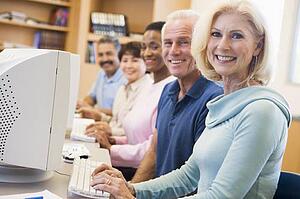 Five people at computer terminals in library (depth of field)