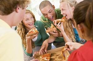 Group Of Teenagers Eating Pizza 