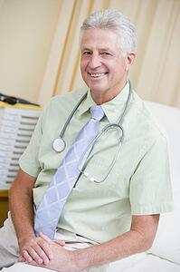 A Doctor Sitting On A Hospital Bed