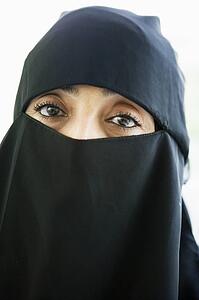Woman wearing black veil indoors (high key)