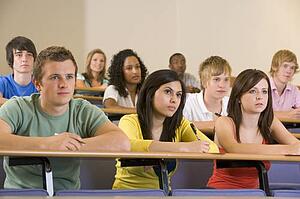Students in class paying attention and taking notes (depth of field)