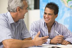 Teacher giving personal instruction to male student