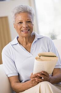Woman relaxing with a book and smiling