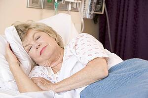 Senior Woman Sleeping In Hospital Bed
