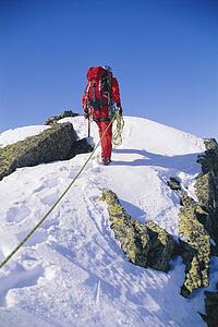 Mountain climber walking on snowy mountain