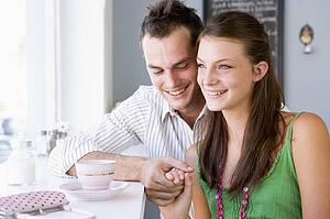Young couple having tea in a cafeteria