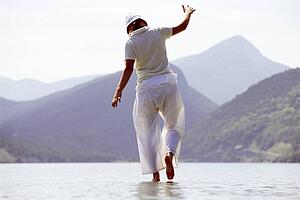 Woman outdoors walking on water in scenic location