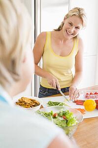 Woman Talking To Friend While Preparing meal, mealtime