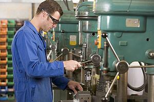 Machinist working on machine