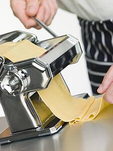 Fresh Egg Pasta being rolled in a Pasta Machine