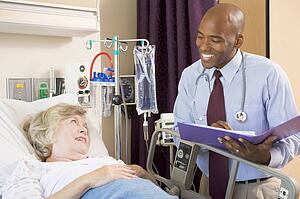 Doctor Making Notes About Patient