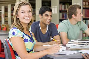 Three people in library studying (selective focus)