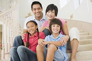Family sitting on staircase smiling