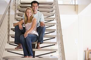 Couple sitting on staircase smiling