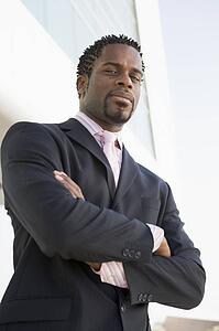 Businessman standing outdoors by building