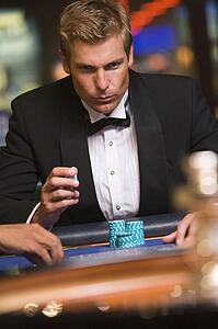 Man in casino playing roulette (selective focus)