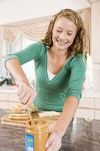 Teenage Girl Making Peanut Butter Sandwich
