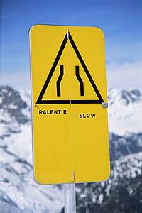 Slow sign on snowy mountain (selective focus)