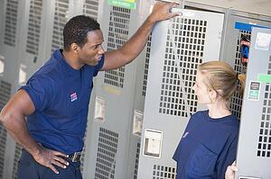 Two firefighters in locker room talking (depth of field)
