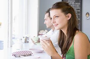 Young couple having tea in a cafeteria