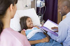 Doctor Making Notes On Patient
