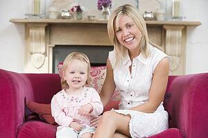 Mother in living room with baby smiling