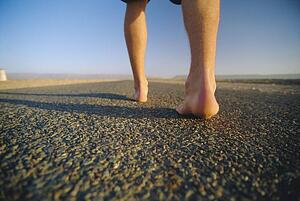 Man's feet on a path outdoors (selective focus)