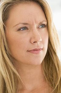 Head shot of woman scowling