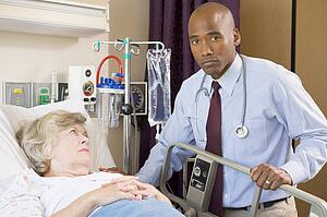 Doctor Checking Up On Patient, Looking Serious