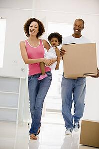 Family moving into new home smiling