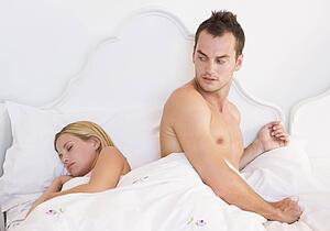 Young couple in bed having trouble sleeping