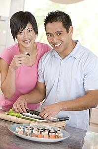 Couple Preparing Sushi Together 