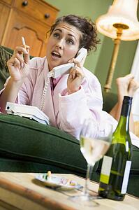 Young woman at home talking on telephone