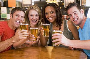 Two couples having beer together