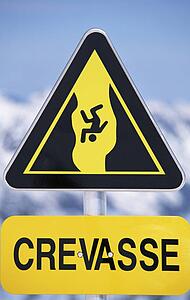 Crevasse sign on snowy mountain (selective focus)