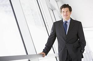 Businessman standing in corridor smiling