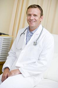 A Doctor Sitting On A Hospital Bed