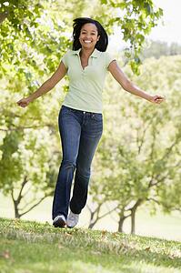 Woman running outdoors smiling