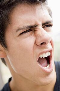 Head shot of man scowling