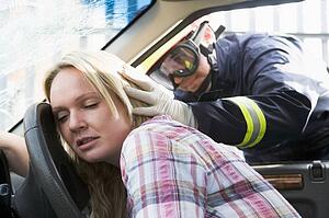 Fireman helping a woman after she got in an accident