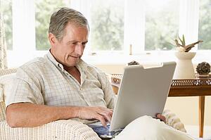Man in living room with laptop