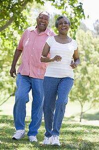 Senior couple walking in park together