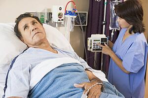 Doctor Helping Middle Aged Man