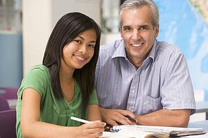 Teacher giving personal instruction to female student